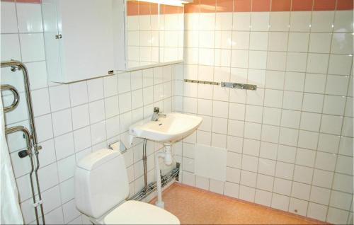 a bathroom with a toilet and a sink at Amazing Apartment In Sysslebck With House A Mountain View in Branäs