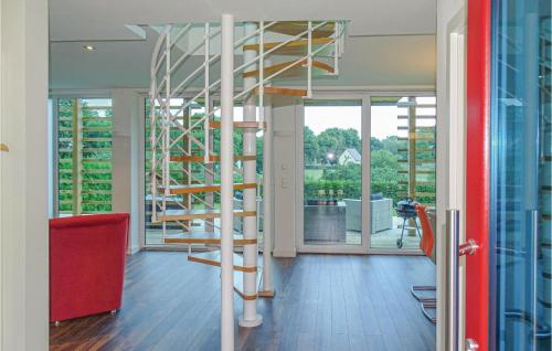 a living room with a spiral staircase and a large window at Cozy Home In Kuhlen Wendorf With Wifi in Wendorf