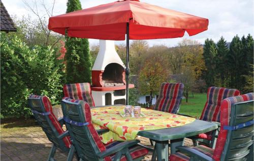 a table and chairs with a table and an umbrella at Ferienhaus 12 In Kirchheim in Kirchheim