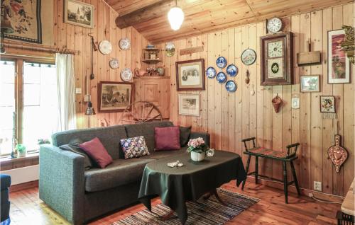 a living room with a couch and a table at 1 Bedroom Lovely Home In Örkelljunga in Åsljunga
