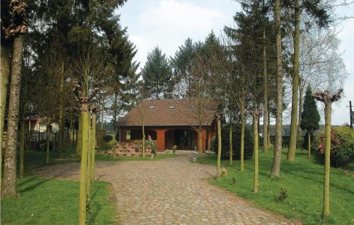 a house with a brick driveway in front of a building at Flamenco in Wachtebeke