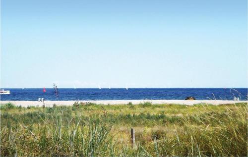 a beach with the ocean and boats in the water at Frische Brise 16 - Dorf 3 in Priwall
