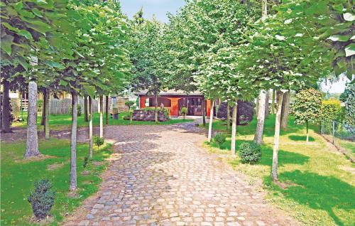 a cobblestone path through a garden with trees at Flamenco in Wachtebeke