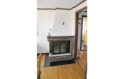 a living room with a fireplace in a room at Holiday Home Tällås Eksjö in Hult