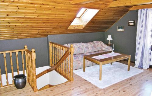 a living room with a couch and a table at Holiday Home Tällås Eksjö in Hult