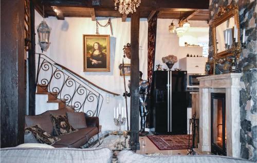 a living room with a staircase and a fireplace at Lovely Home In Klippan With Sauna in Klippan