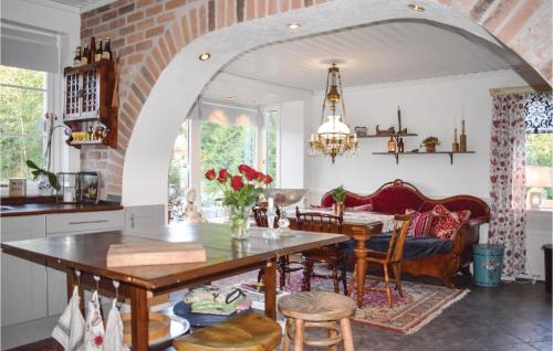 an archway in a kitchen with a table and chairs at Lovely Home In Klippan With Sauna in Klippan