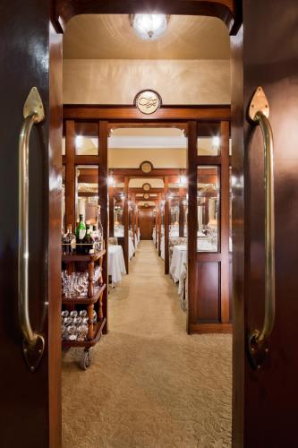 a corridor of a restaurant with tables and chairs at Taj Palace, New Delhi in New Delhi