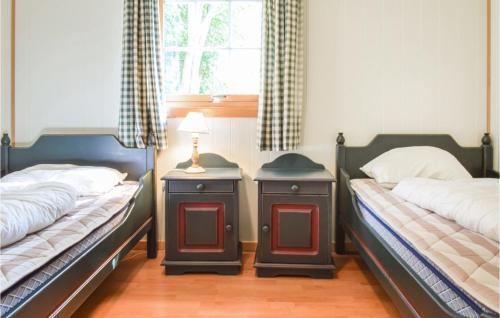 two beds sitting next to each other in a bedroom at Eikhaugen Gjestegard in Vinnes