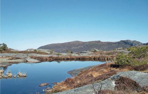 a body of water with mountains in the background at Eikhaugen Gjestegard in Vinnes