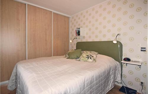 a small bedroom with a bed with a white blanket at One-Bedroom Holiday Home In Fagersanna in Fagersanna