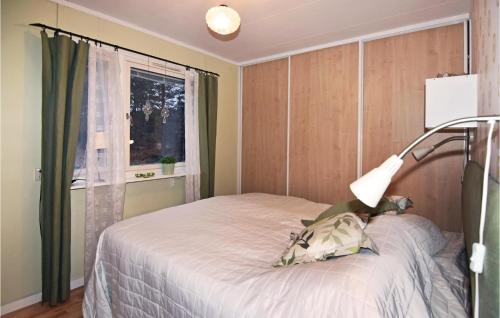 a bedroom with a bed with a lamp on it at Awesome Home In Fagersanna With 1 Bedrooms in Fagersanna