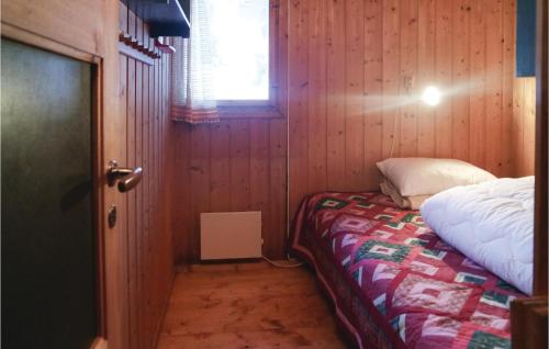 SjusjøenにあるGorgeous Home In Sjusjen With Saunaのベッドと窓が備わる小さな客室です。