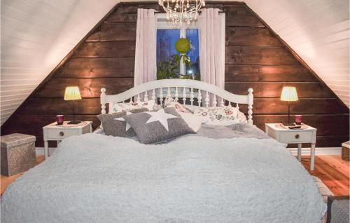 a bedroom with a white bed with two night stands at Amazing Home In Holmsjö in Holmsjö