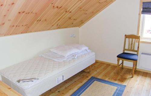 a bed in a room with a wooden ceiling at Beautiful Home In Fjällbacka With Sauna in Fjällbacka