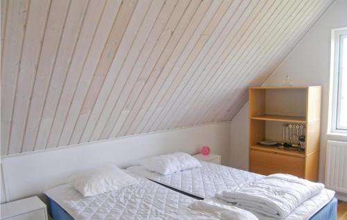 a bedroom with a bed with two pillows on it at 3 Bedroom Awesome Home In Ystad in Ystad
