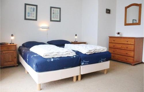 a bedroom with two beds and a dresser at Amazing Apartment In Breskens With Wifi in Breskens