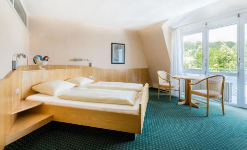 Letto o letti in una camera di Bike- und Ferienhotel Freiburg