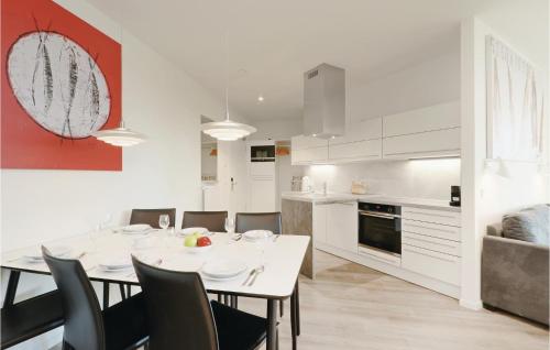 a dining room and kitchen with a white table and chairs at Highend Travemünde - Whg 07 in Travemünde
