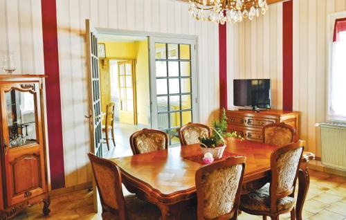 a dining room with a wooden table and chairs at Nice Home In Senlecques With Kitchen in Senlecques