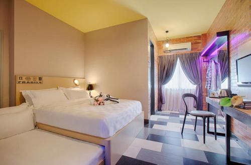 a hotel room with a bed and a desk and a chair at the youniQ Hotel, Kuala Lumpur International Airport in Sepang