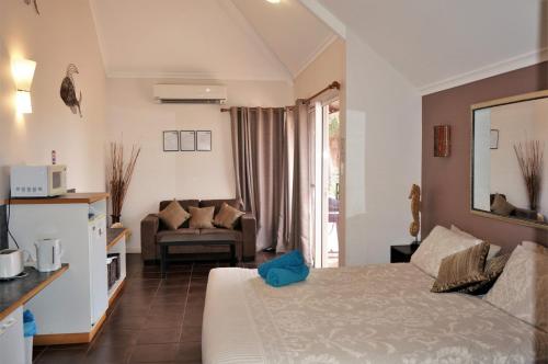 a hotel room with a bed and a living room at Osprey Holiday Village Unit 213 1 Bedroom in Exmouth