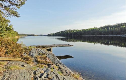 a view of a lake with a wooden bridge at Holiday Home Kilane Ånimskog in Säljebyn