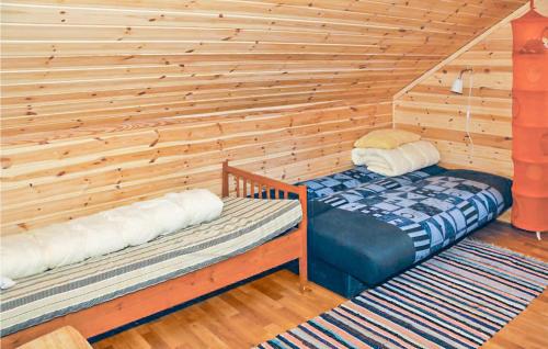 a room with two beds in a wooden cabin at Amazing Home In Vaksdal With 4 Bedrooms And Internet in Stavenesli