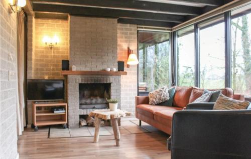 a living room with a couch and a fireplace at Three-Bedroom Holiday Home In Reutum in Reutum
