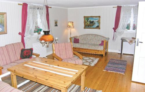 a living room with a table and a couch at Gormetorp in Barnebo