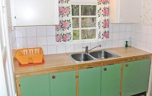 a kitchen counter with a sink and a window at Gormetorp in Barnebo