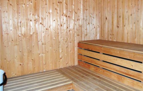 a sauna with wooden walls and a wooden bench in it at Gorgeous Home In Ruda With Kitchen in Ruda