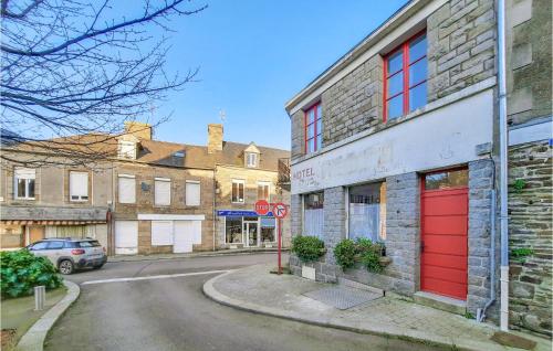 an old building with red doors on a street at 2 Bedroom Awesome Apartment In Antrain in Antrain