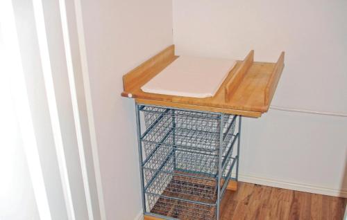 a room with a table and a basket under it at Cozy Home In Jönköping With Wifi in Norrahammar