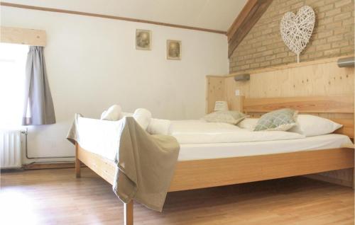 a bedroom with two beds and a brick wall at Vakantiewoning 11 in Simpelveld