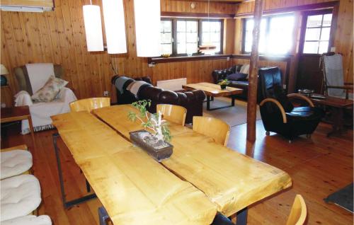 a dining room with a wooden table and chairs at Nice Home In Kälarne With Sauna in Övsjöbyn