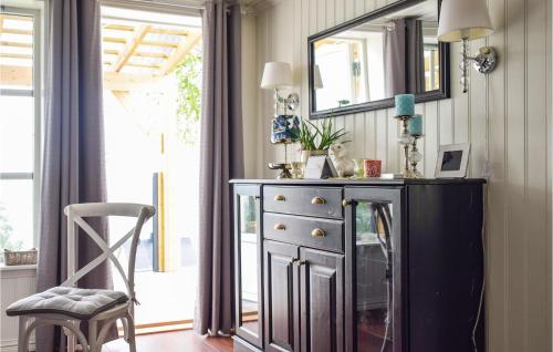 a dresser with a mirror and a chair in a room at Cozy Home In Ballangen With Wifi in Ballangen