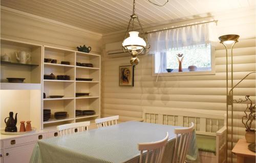 a dining room with a table and chairs and a window at Awesome Apartment In Stathelle With Sauna in Stathelle