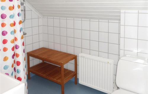a small bathroom with a table and a toilet at One-Bedroom Holiday Home In Jonkoping in Jönköping