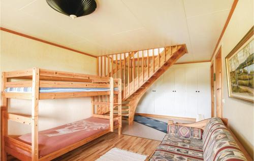 SvanskogにあるBeautiful Home In Svanskog With 2 Bedrooms And Wifiの二段ベッド2台とソファが備わる客室です。