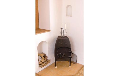 a small fireplace in a corner of a room at Pet Friendly Home In Fröseke With Sauna in Fröseke