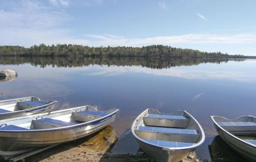 three boats sitting on the shore of a lake at Amazing Home In Vittaryd With Wifi in Kvänarp