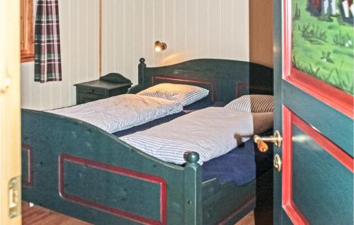 two beds in a room with a door open at Eikhaugen Gjestegard in Vinnes
