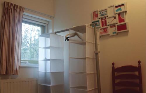 a white refrigerator in a room with a window at Fonteinbos in Oudemirdum