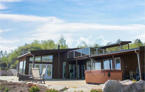 a house with glass walls and a tub at Åmland Hyttefelt in Korshamn