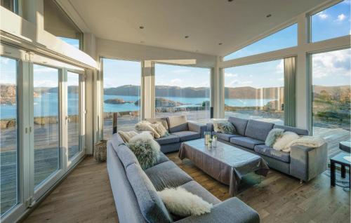 a living room with couches and a view of the water at Åmland Hyttefelt in Korshamn