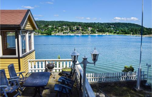 a house with a balcony with a view of a lake at Three-Bedroom Holiday Home In Nordre Frogn in Brevik