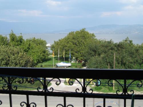 a balcony with a view of a park with a boat at Apartmani Alex Beach in Star Dojran