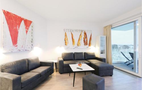 a living room with a couch and a table at Priwallpromenade 23, Whg 10 in Travemünde