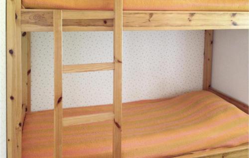 a wooden bunk bed in a room at Beautiful Home In Arvika With 2 Bedrooms in Vik